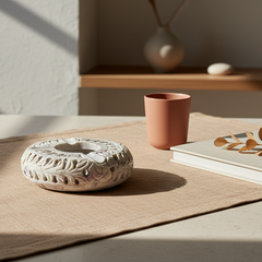 Premium Hand-Carved Soapstone Ash Tray on a table with a cup and book in the background