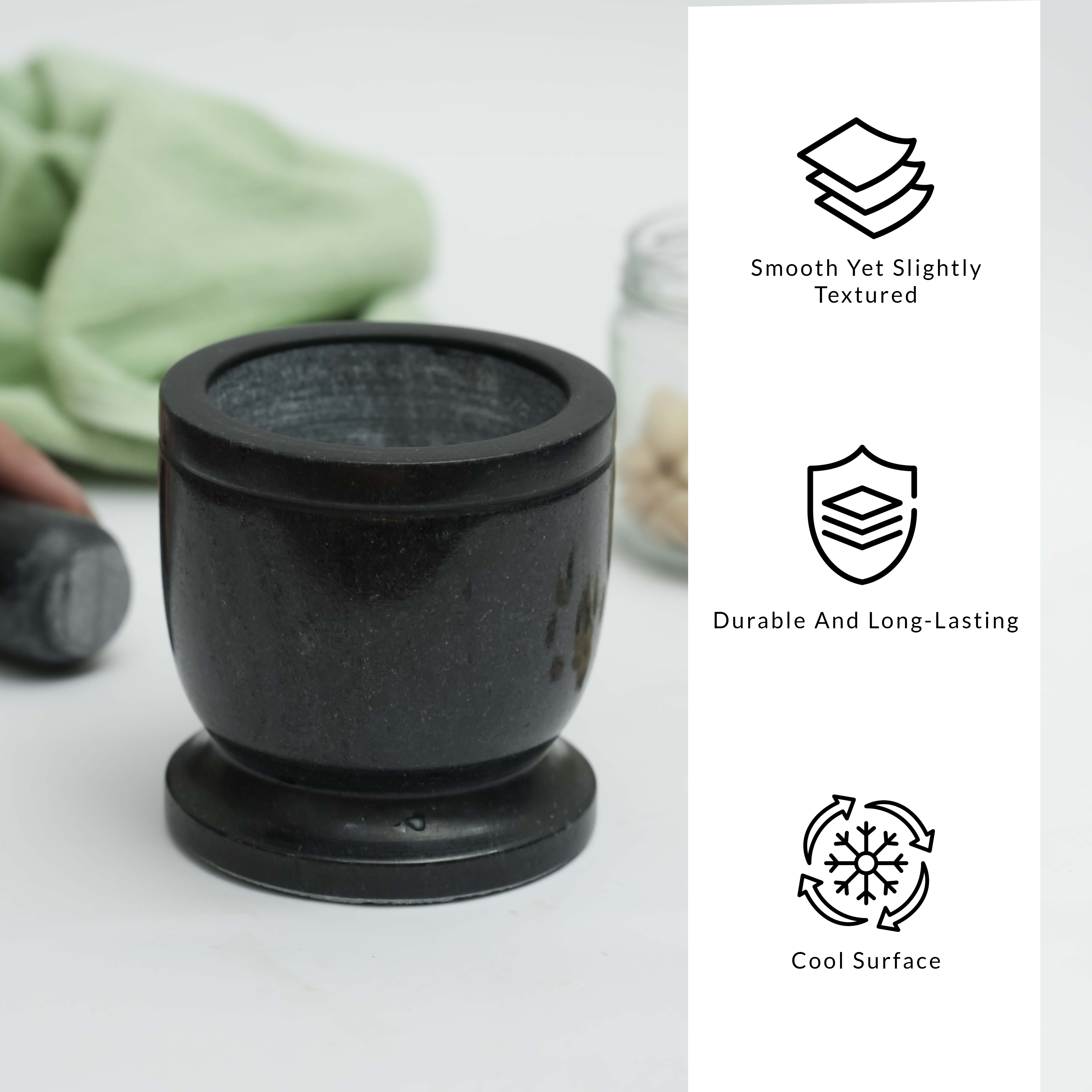 Black marble mortar and pestle on a white surface with text describing its features.