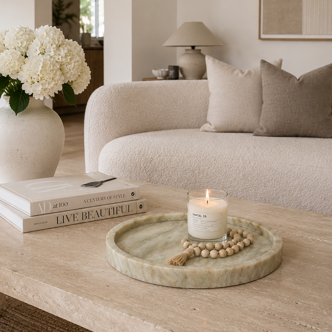 Natural stone marble tray styled in a minimalist living room with candle and decorative accessories.