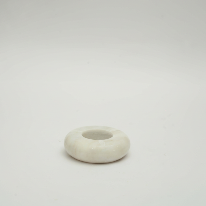 White marble ash tray on a light gray background
