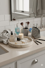 Marble vanity tray displayed with Bathroom counter with various items including a candle, bottles, and makeup brushes.