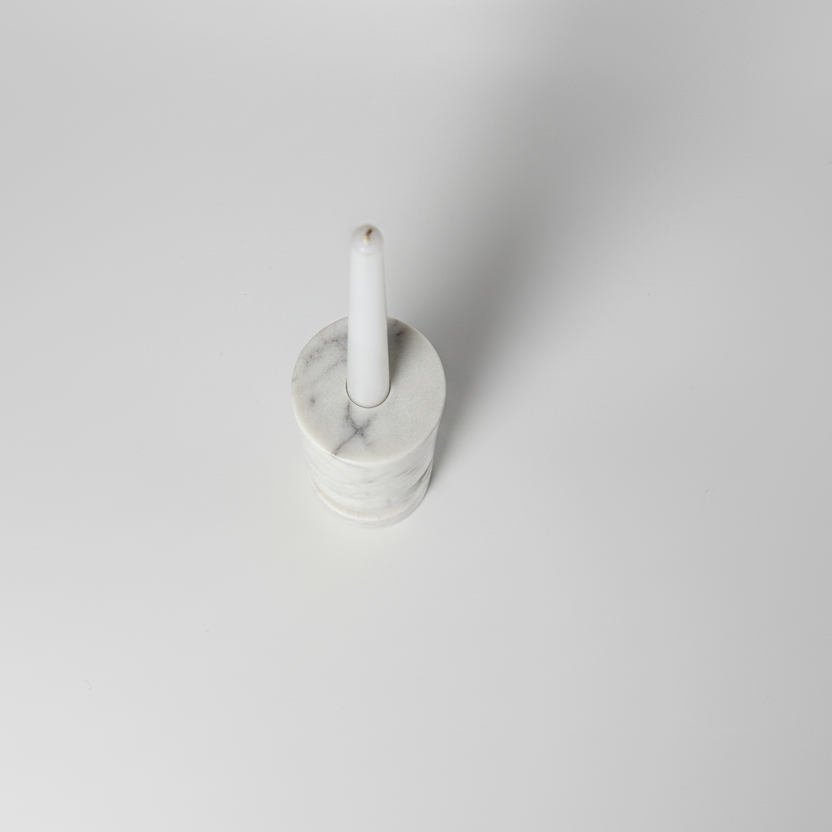 Banswara marble candle holder with lit candle photographed from above on a minimalist surface
