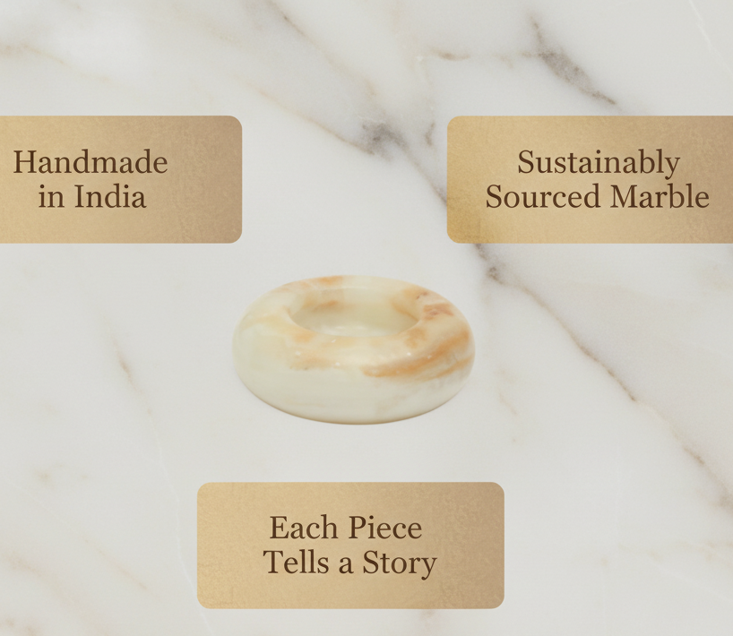 Natural onyx marble ash tray with labels indicating 'Handmade in India', 'Sustainably Sourced Marble', and 'Each Piece Tells a Story' on a marble background.