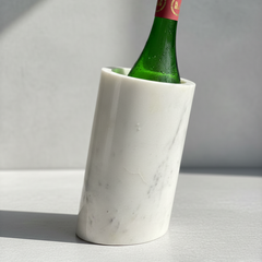 Premium white marble wine chiller bucket holding a chilled wine bottle on a minimalist surface