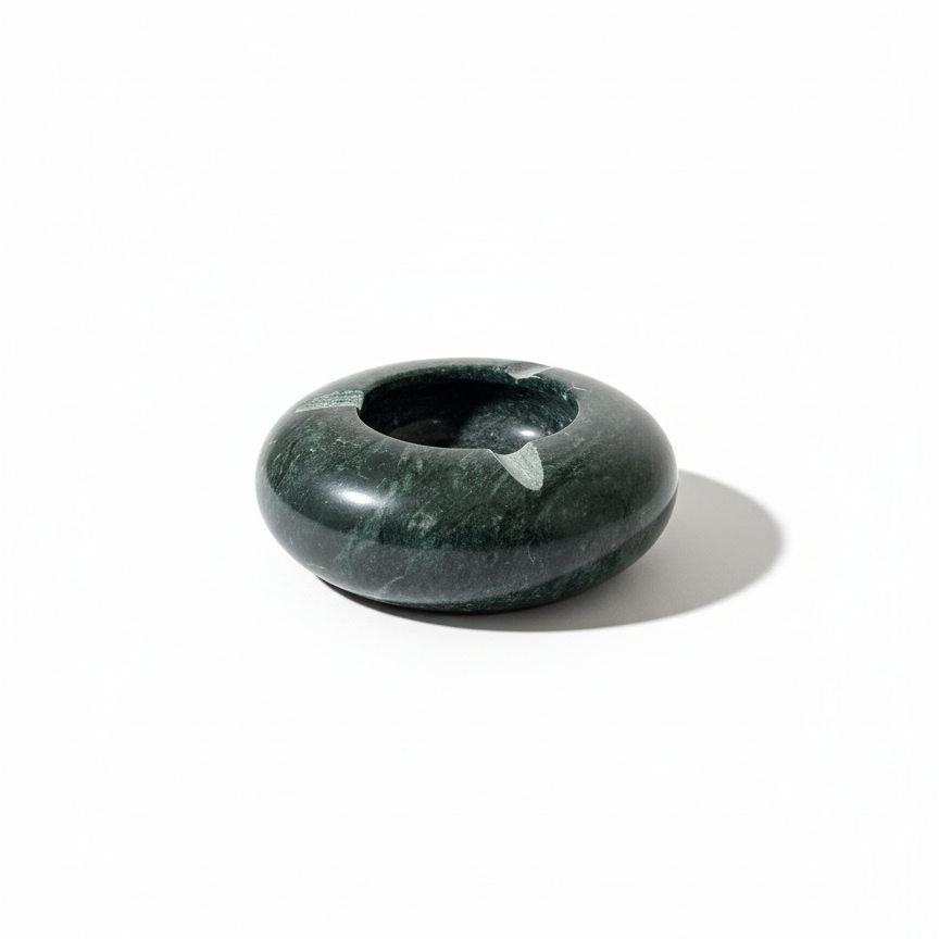 Top view of a handcrafted green marble ashtray on a white background