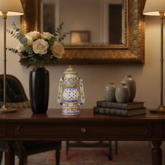 Decorative hand-painted marble lantern displayed on an elegant entryway console table.