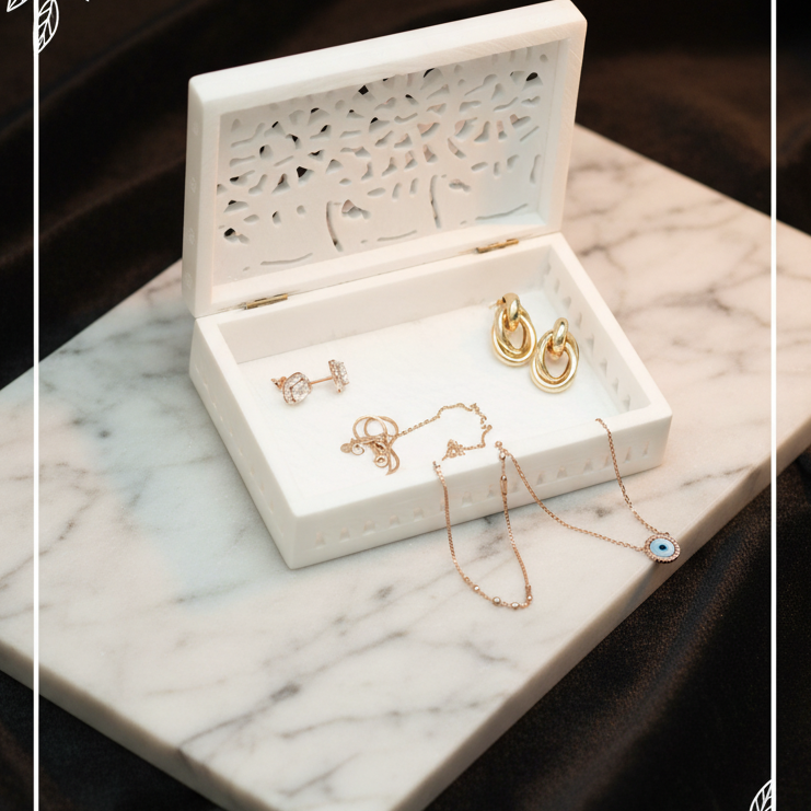 Open Soapstone Jewellery Box with Gold Jewellery on Marble Surface